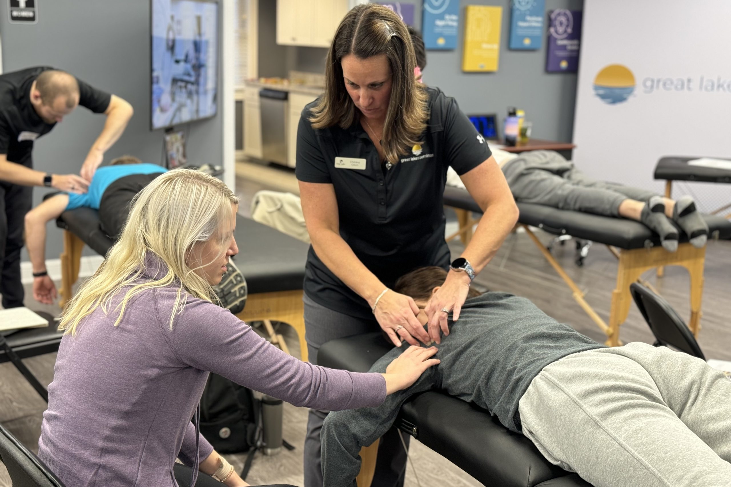 CEU course instructor teaching new MFR techniques to a physical therapist